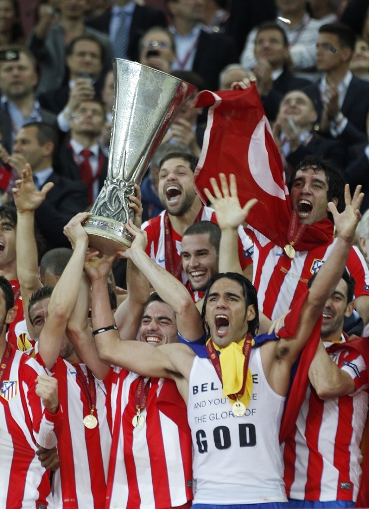 Atletico Madrid's players celebrate with the trophy after defeating Athletic Bilbao to win the Europa League final soccer match at the National Arena in Bucharest